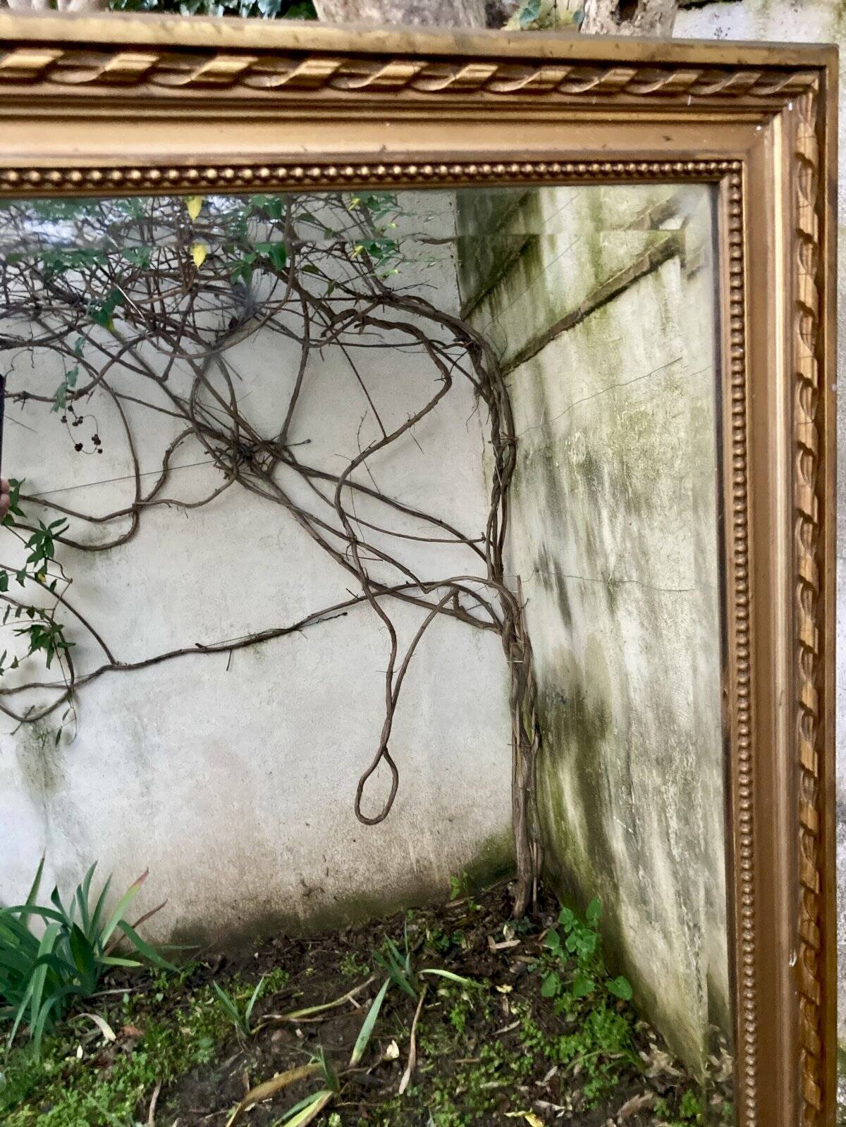 Large antique mirror with bevelled glass bordered by a row of pearls 148 x 88