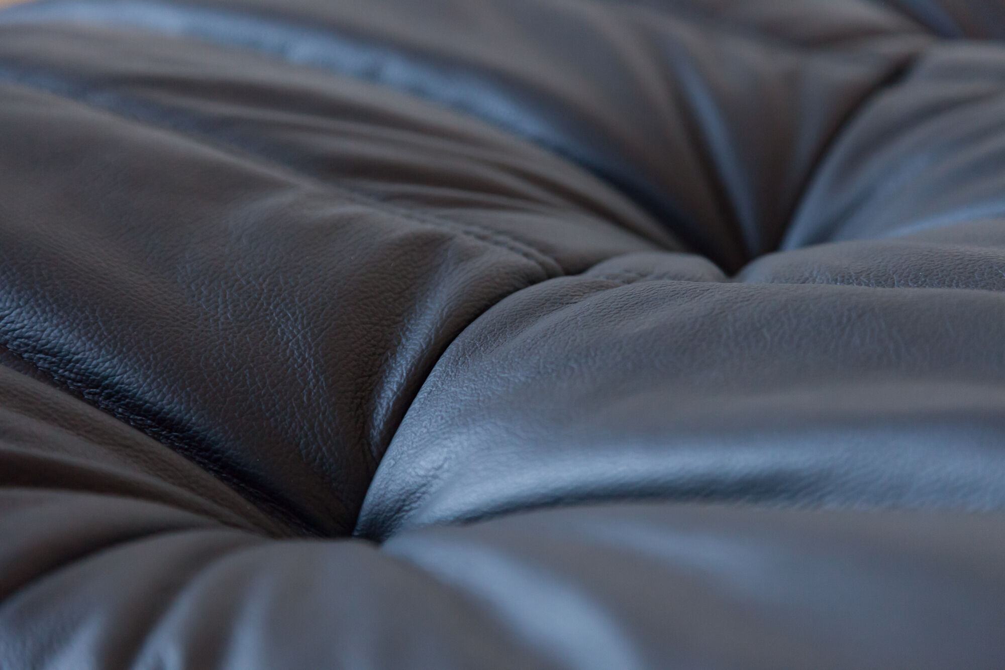 Armchair and ottoman in black leather model designed by Michel Ducaroy 1973
