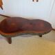 Tripod coffee table - solid okoumé wood - organic shape - brutalist style