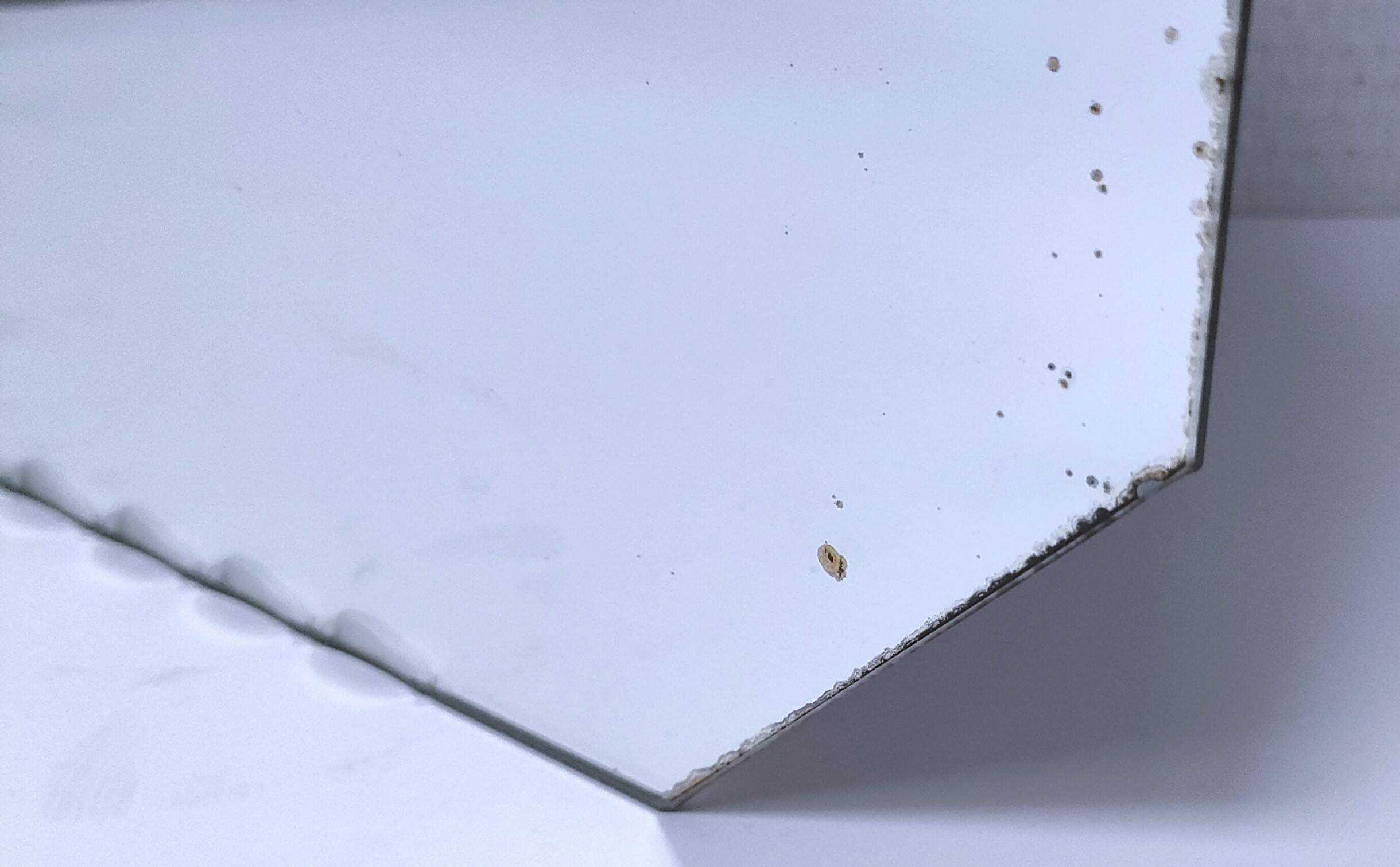 Octagonal mirror with brass hubcaps from the 60s