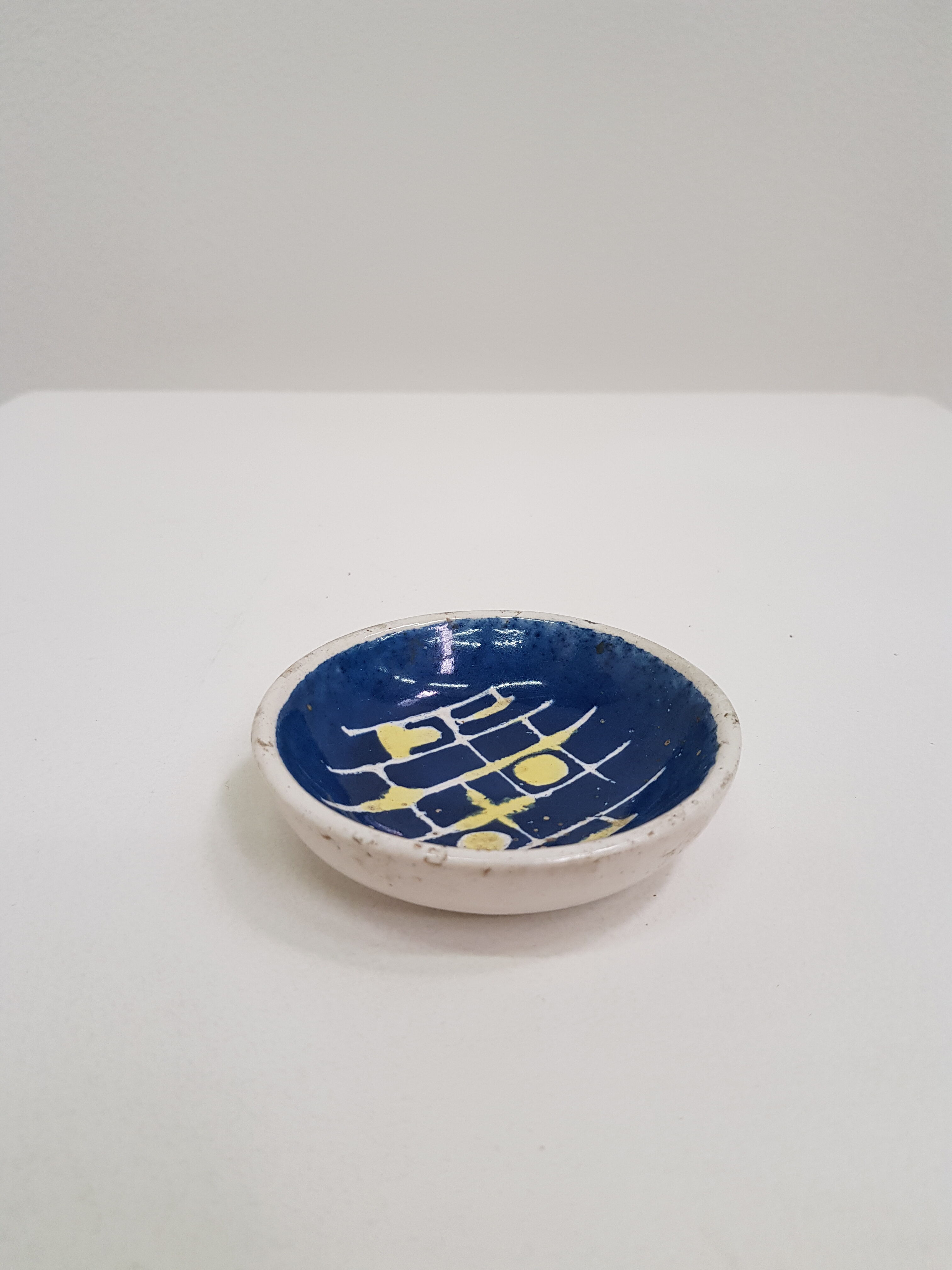 Small cup in white and blue vintage ceramic with yellow motis.