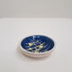 Small cup in white and blue vintage ceramic with yellow motis.