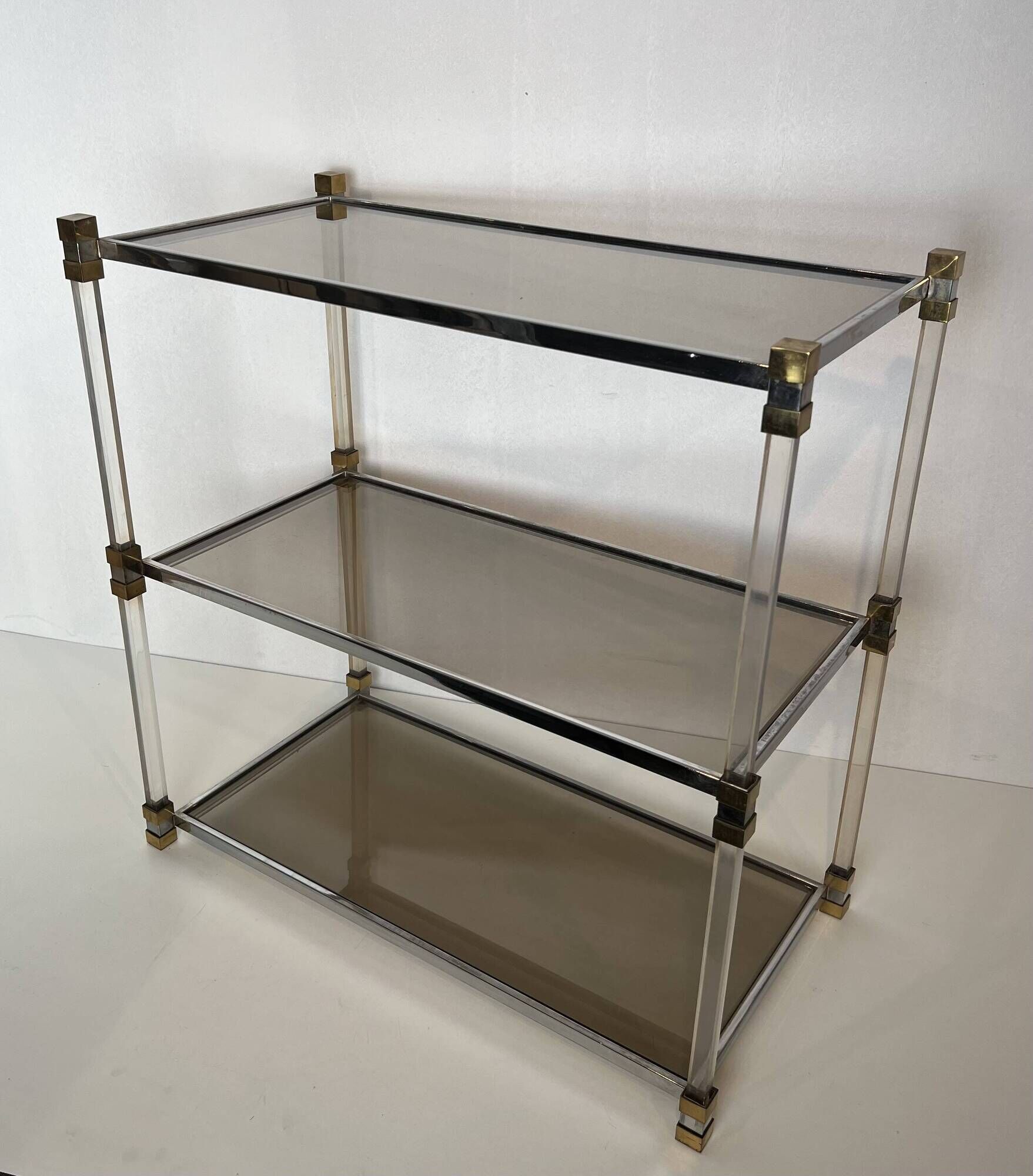 Lucite Shelf with Three Smoked Glass Shelves and Brass Ends. Work
