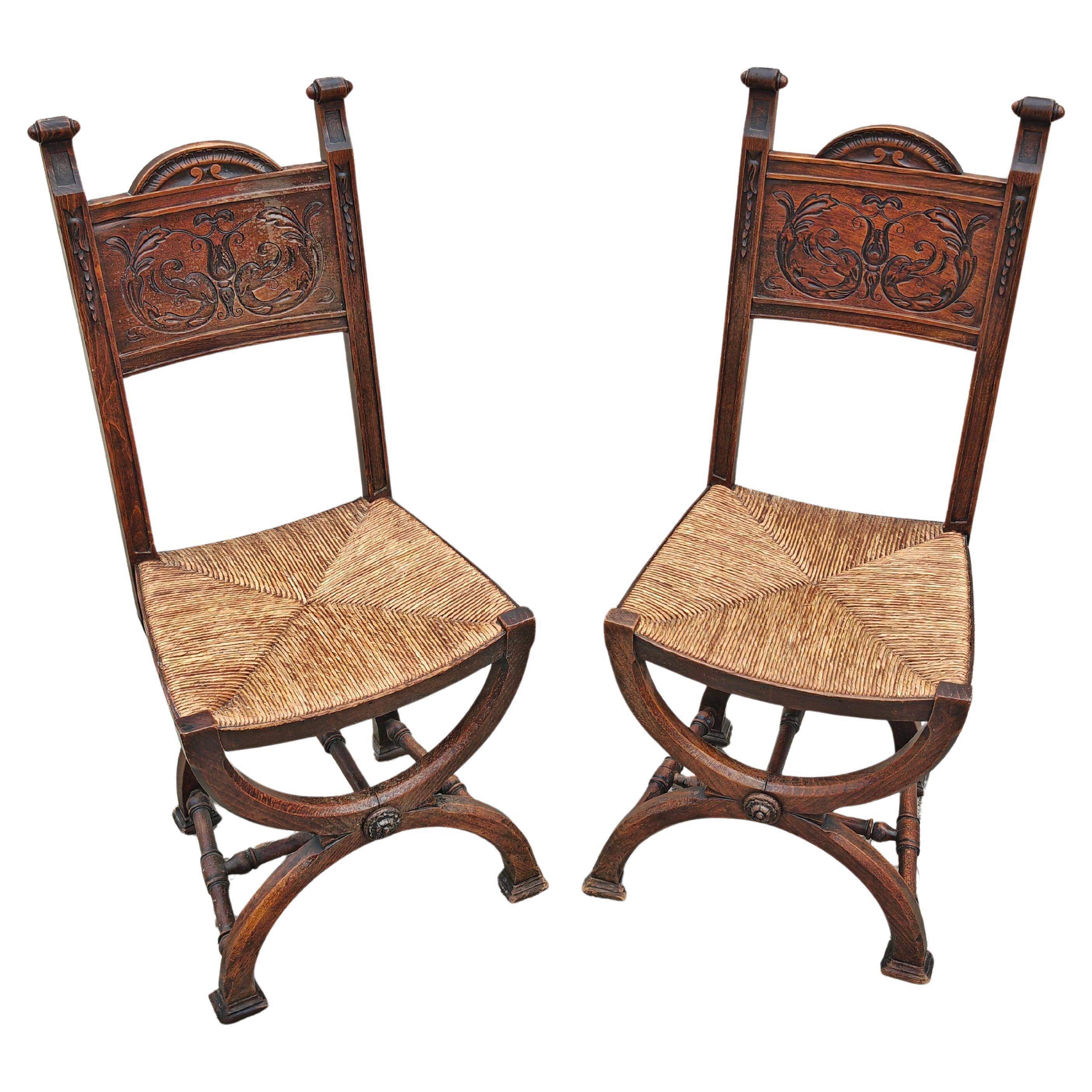 Pair of Neo-Renaissance oak chairs with straw seats, 1910
