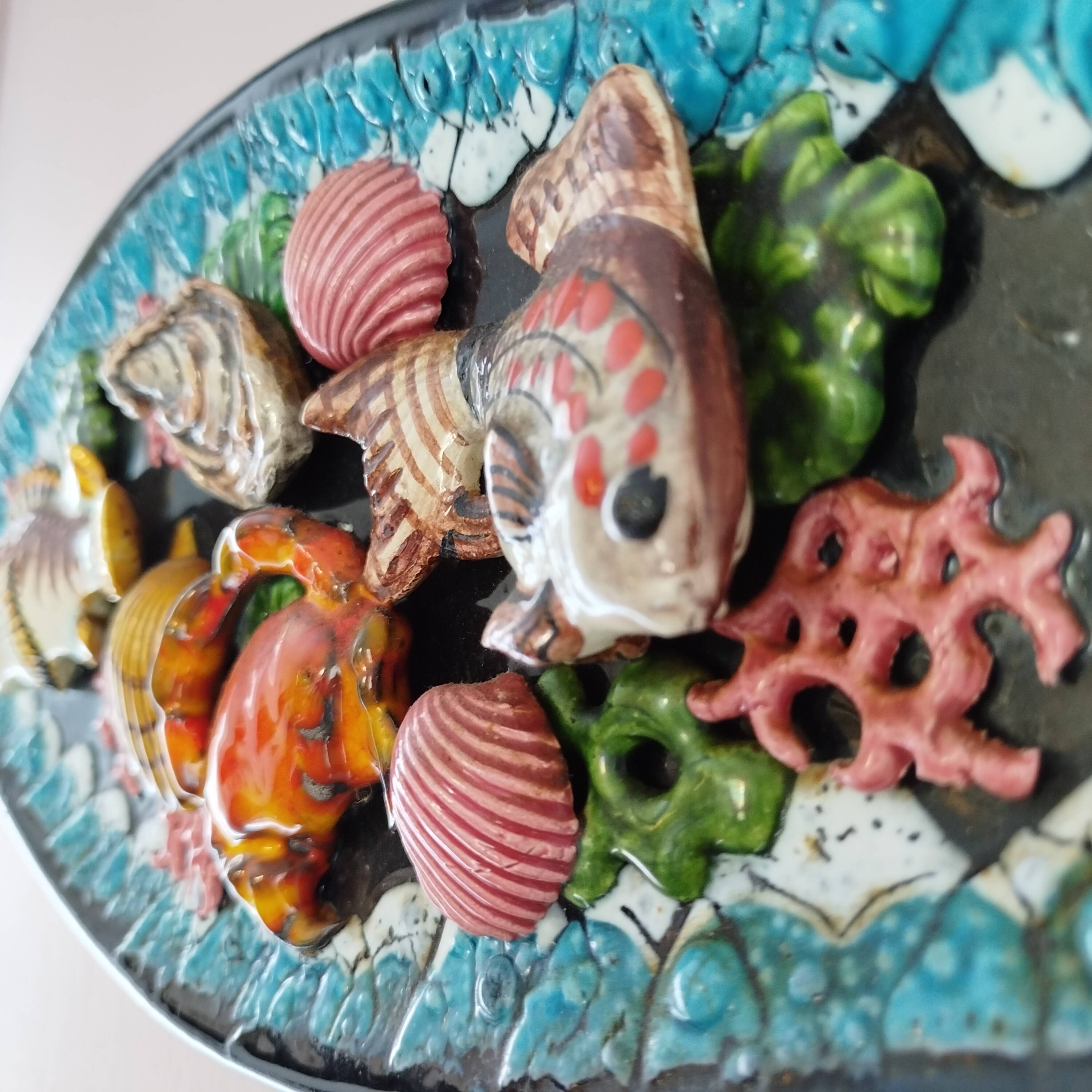 Dish with fish and shells relief decoration