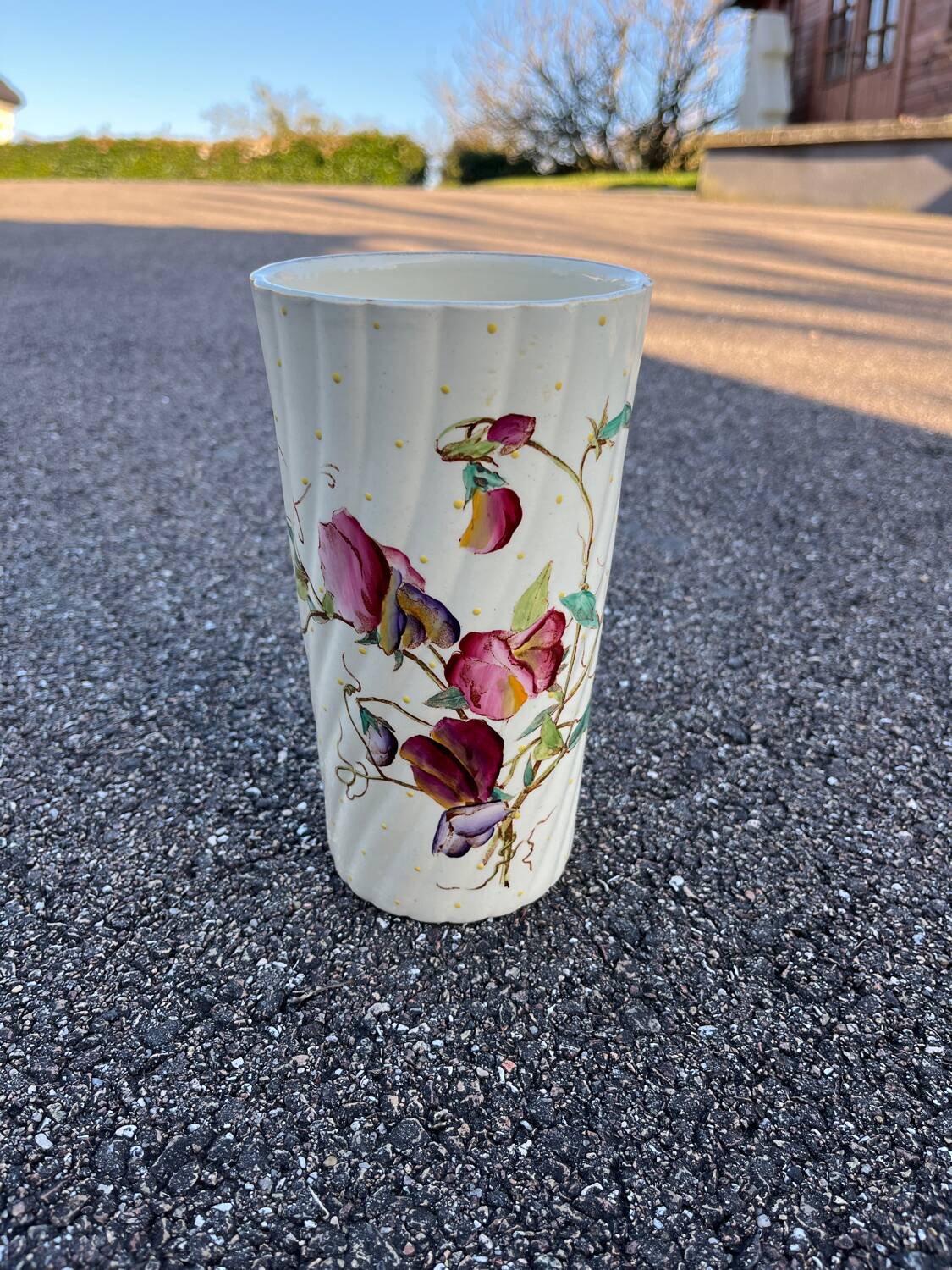 Antique twisted earthenware vase circa 1920, decorated with flowers