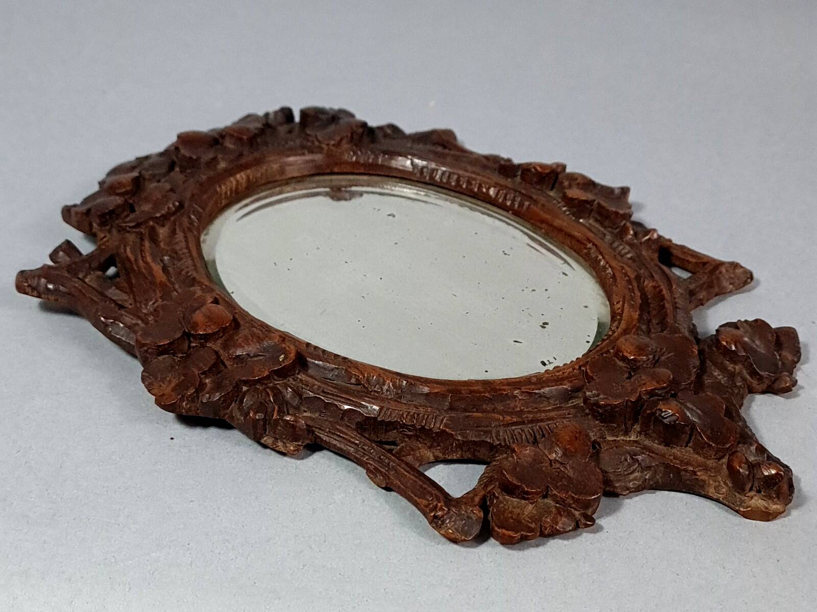 Antique small beveled mirror with carved wooden frame and waxed patina C714