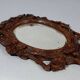 Antique small beveled mirror with carved wooden frame and waxed patina C714