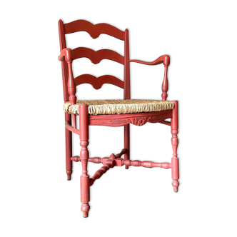 Red wooden armchair and braided plunder