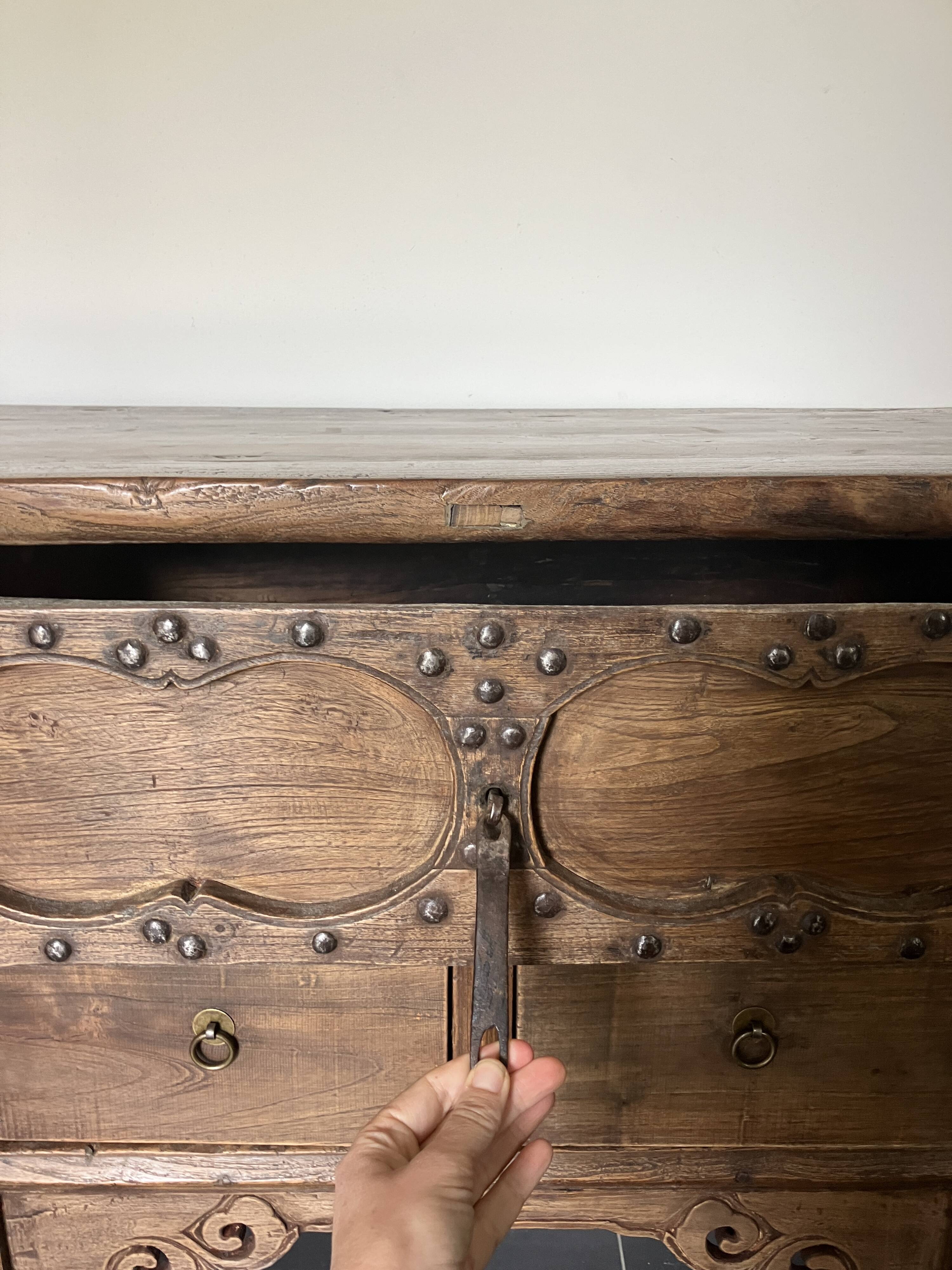 Very old elm wood with carved patterns and ironwork pieces.
