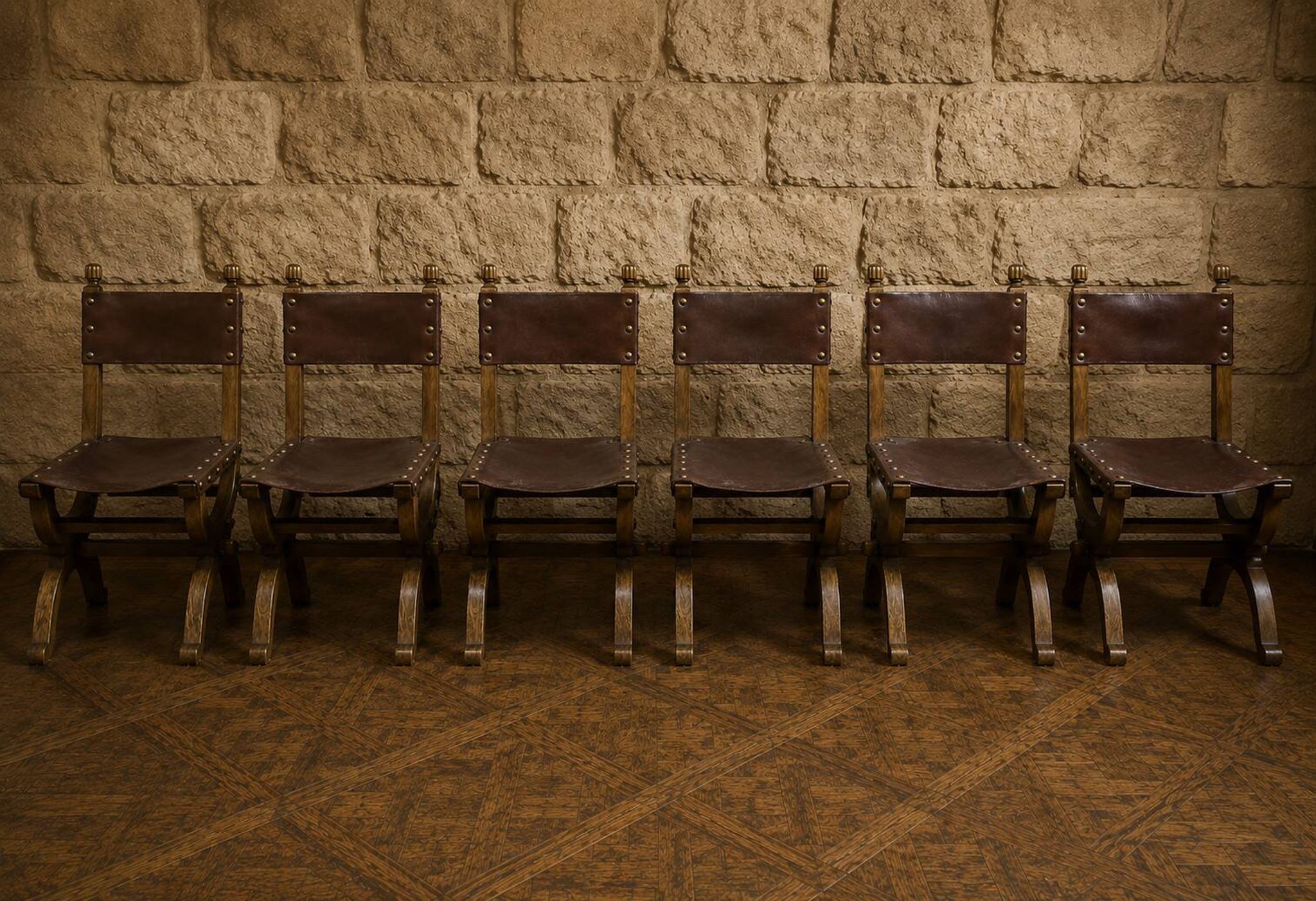 Set of six Renaissance-style chairs in oak and leather.