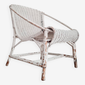 Patinated white rattan armchair