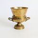Vintage brass cache-pot on a stand with handles, classic decor.