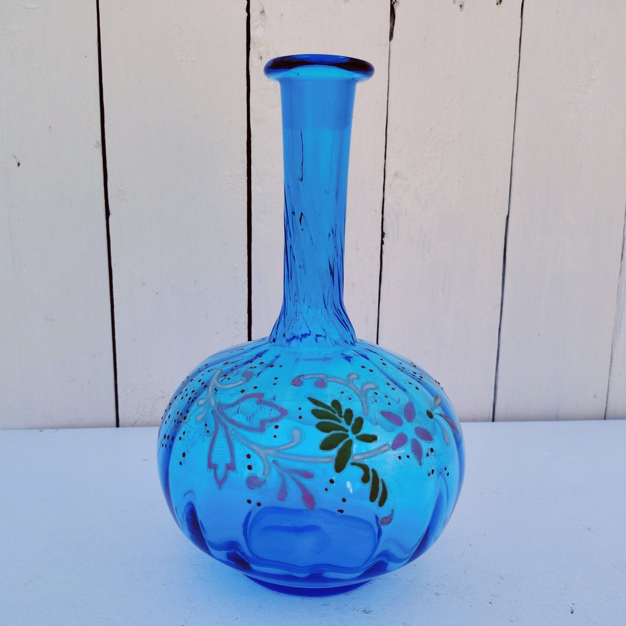 Vintage twisted blue glass carafe with enamel decoration.