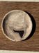 Bowl, plate or circular dish in beige petrified wood with black spots.