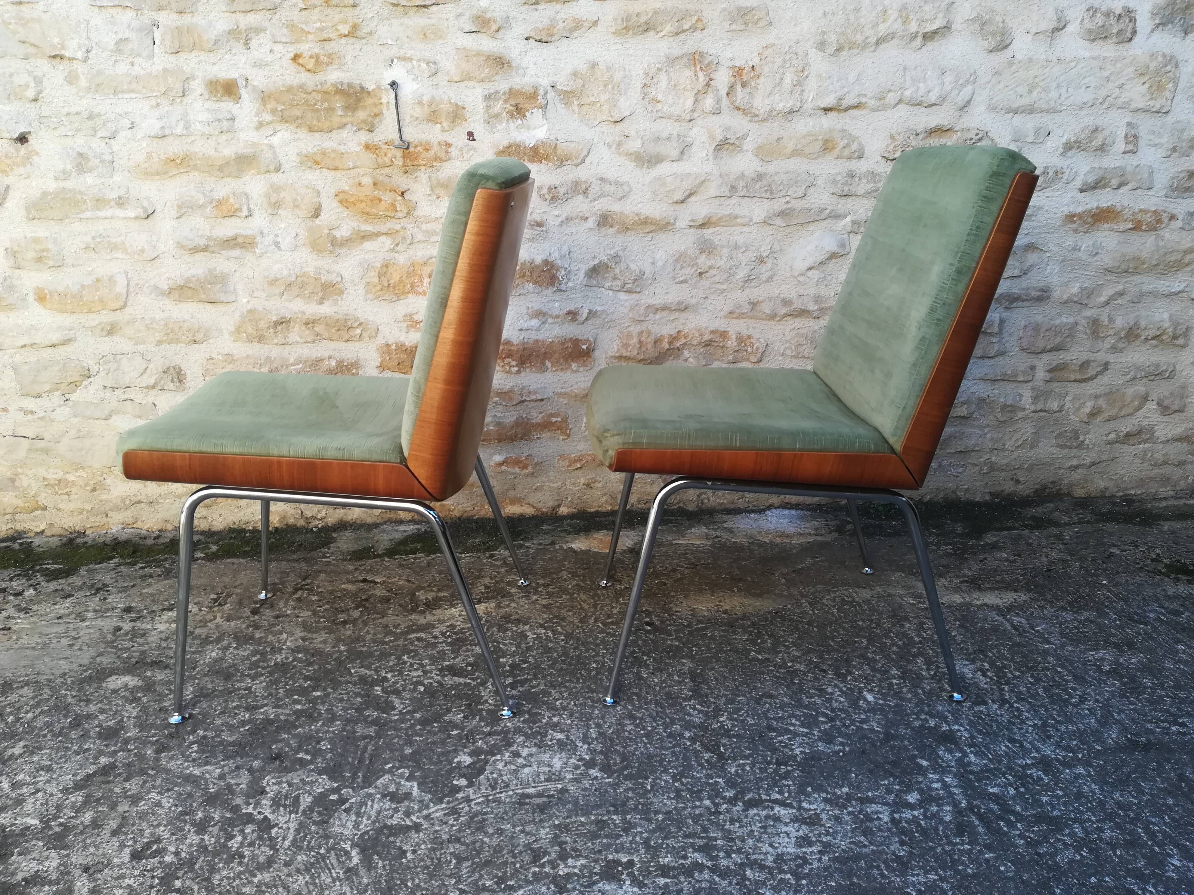 Shell chairs and green fabric