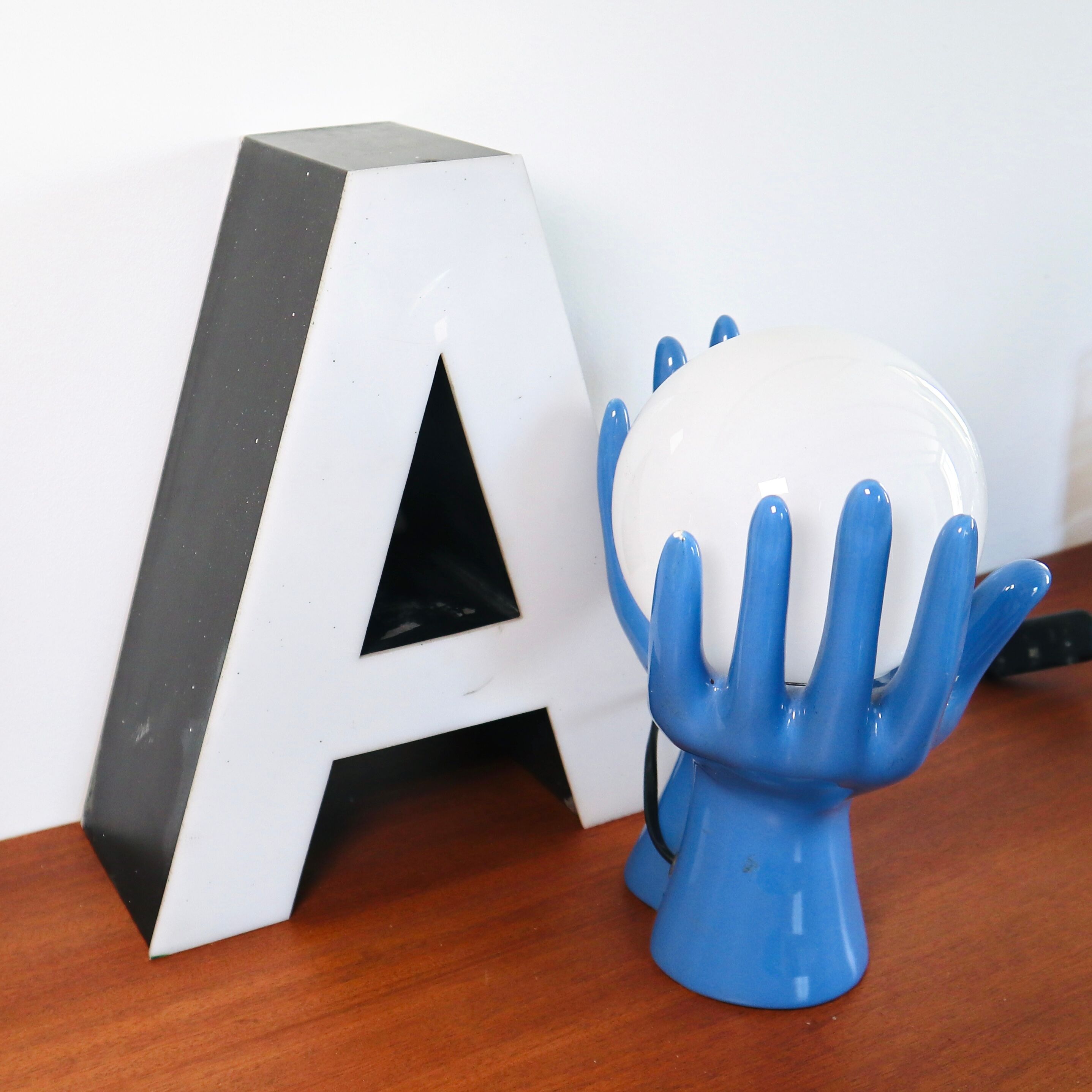 Ceramic lamp hands holding blue globe