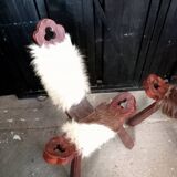 Pair of brutalist tripod chairs in wood and cowhide