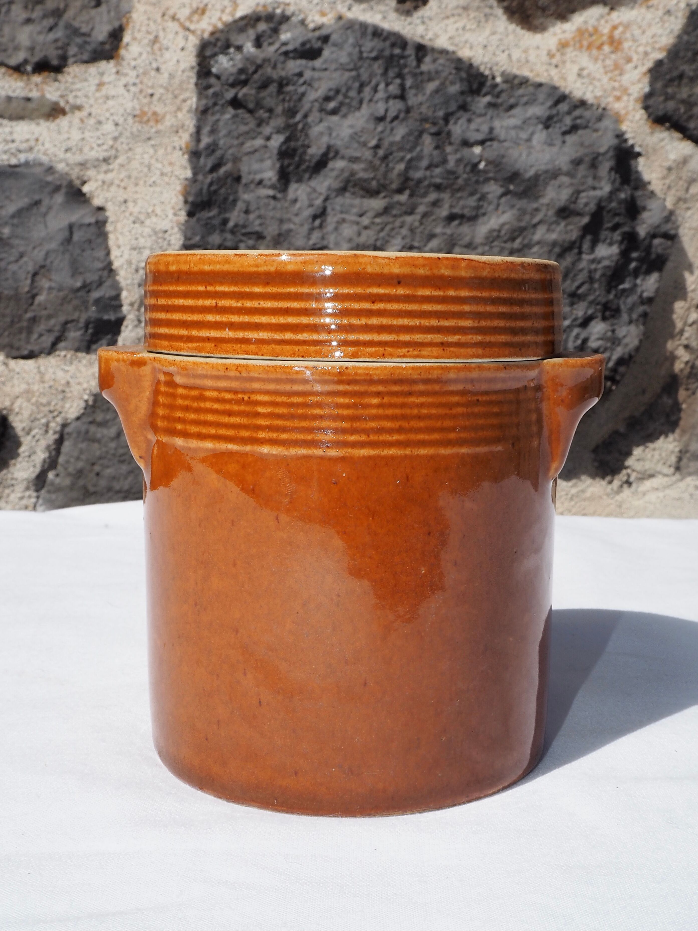 Trio of stoneware pots with lids