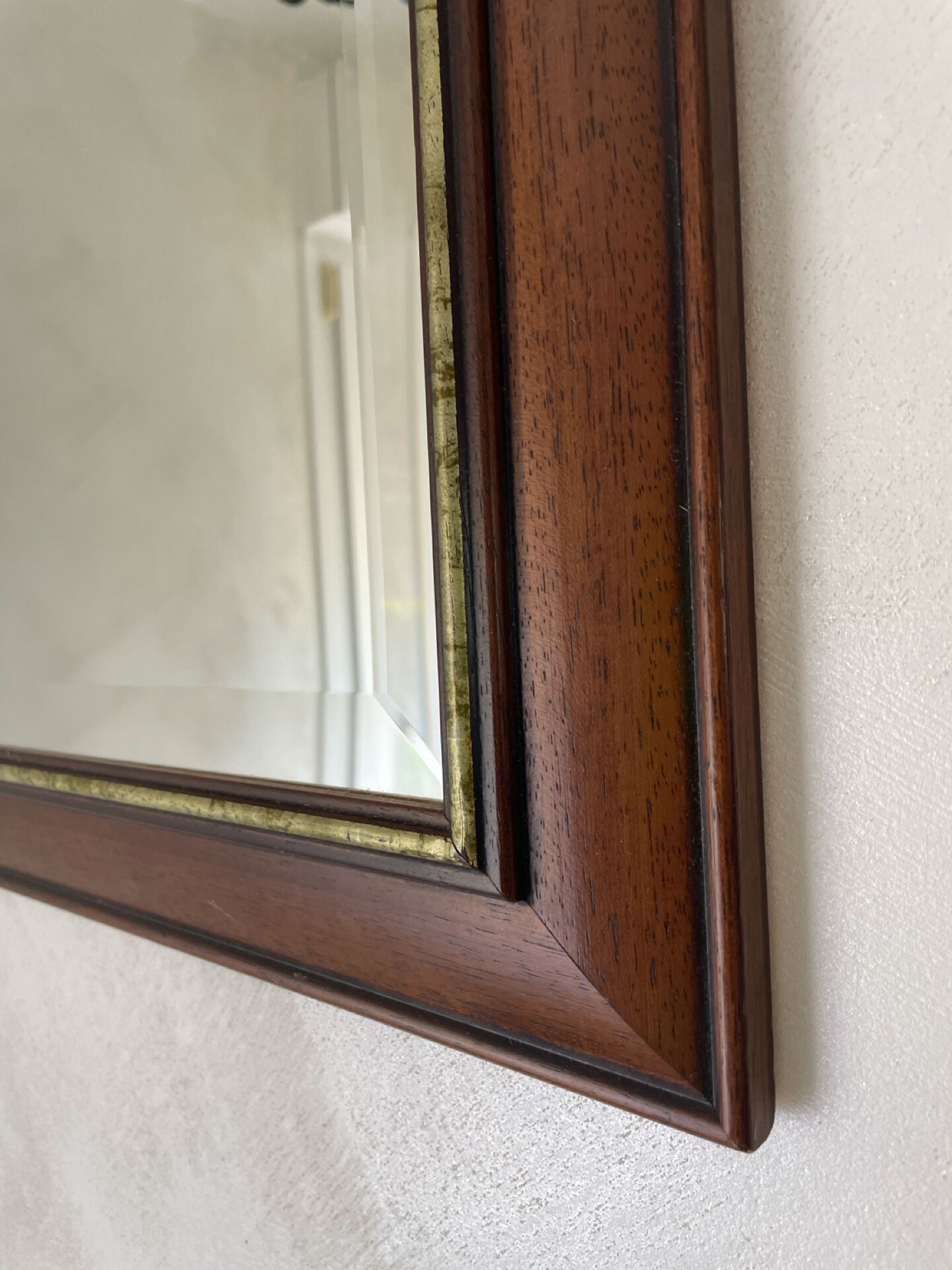 Vintage bevelled wall mirror in stained wood and brass