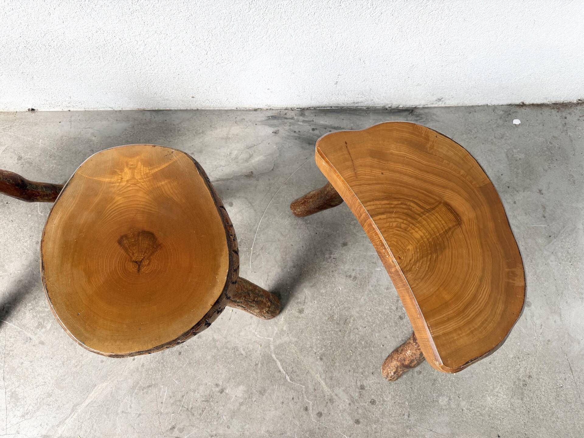 Set of three rustic solid wood tripod stools.
