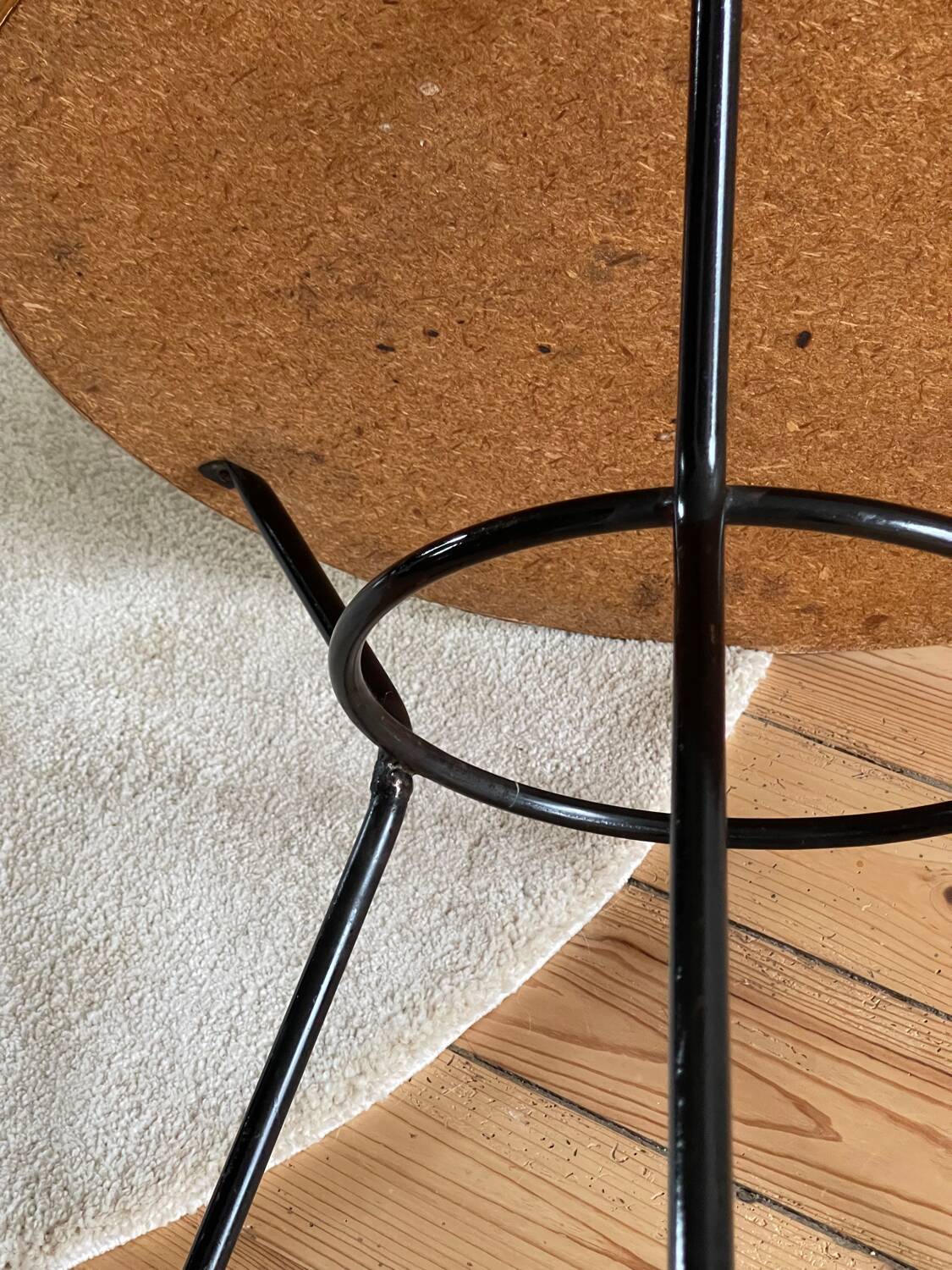 Tripod coffee table with a straw covering.