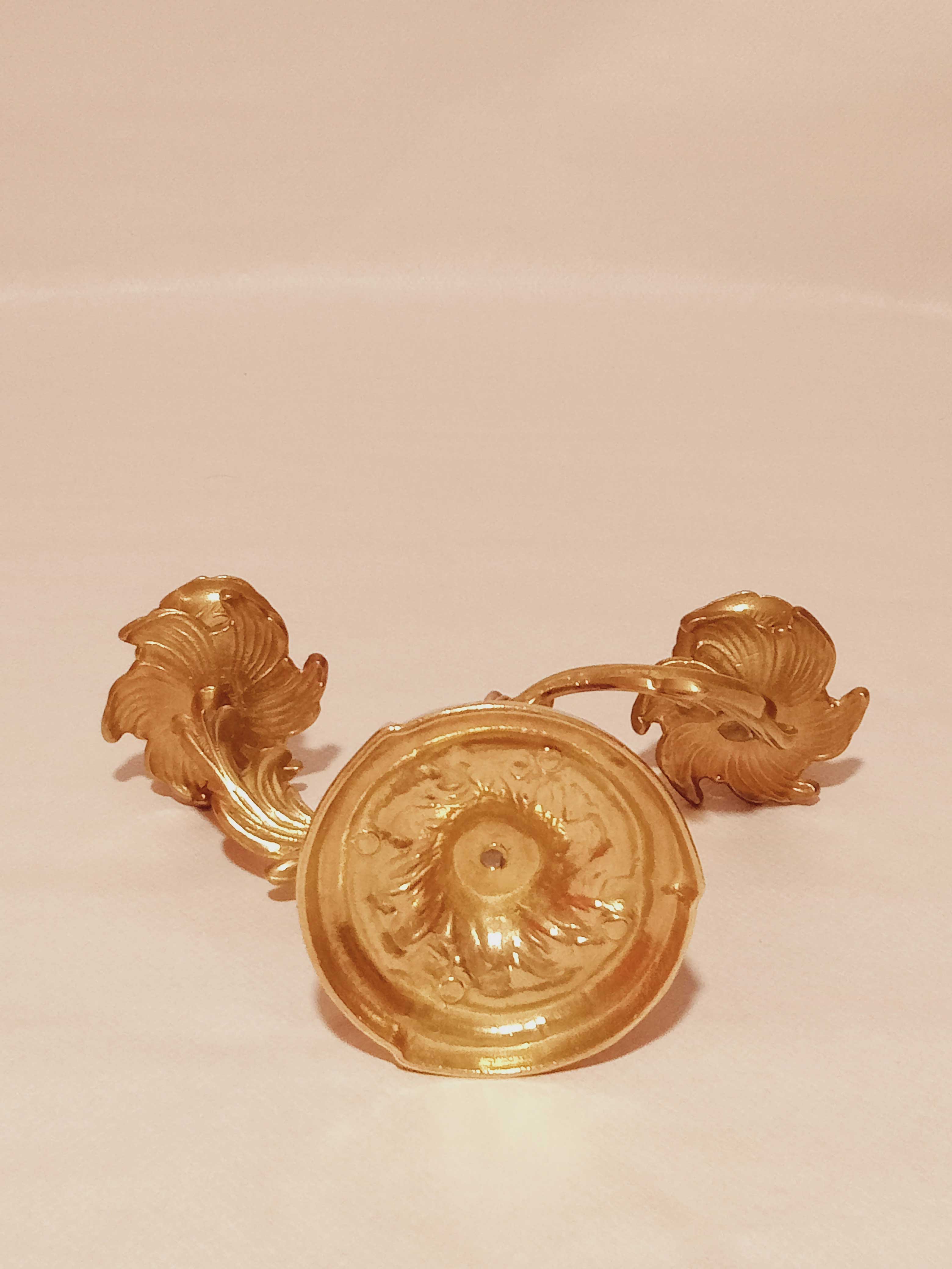 Old candle holder in gilded bronze