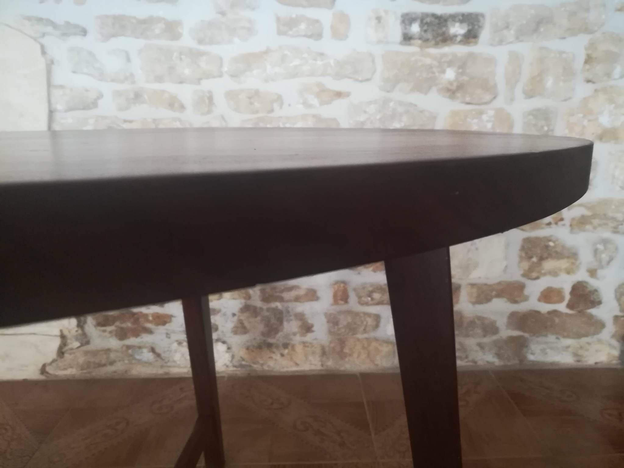Round wooden table with thin legs