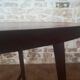 Round wooden table with thin legs
