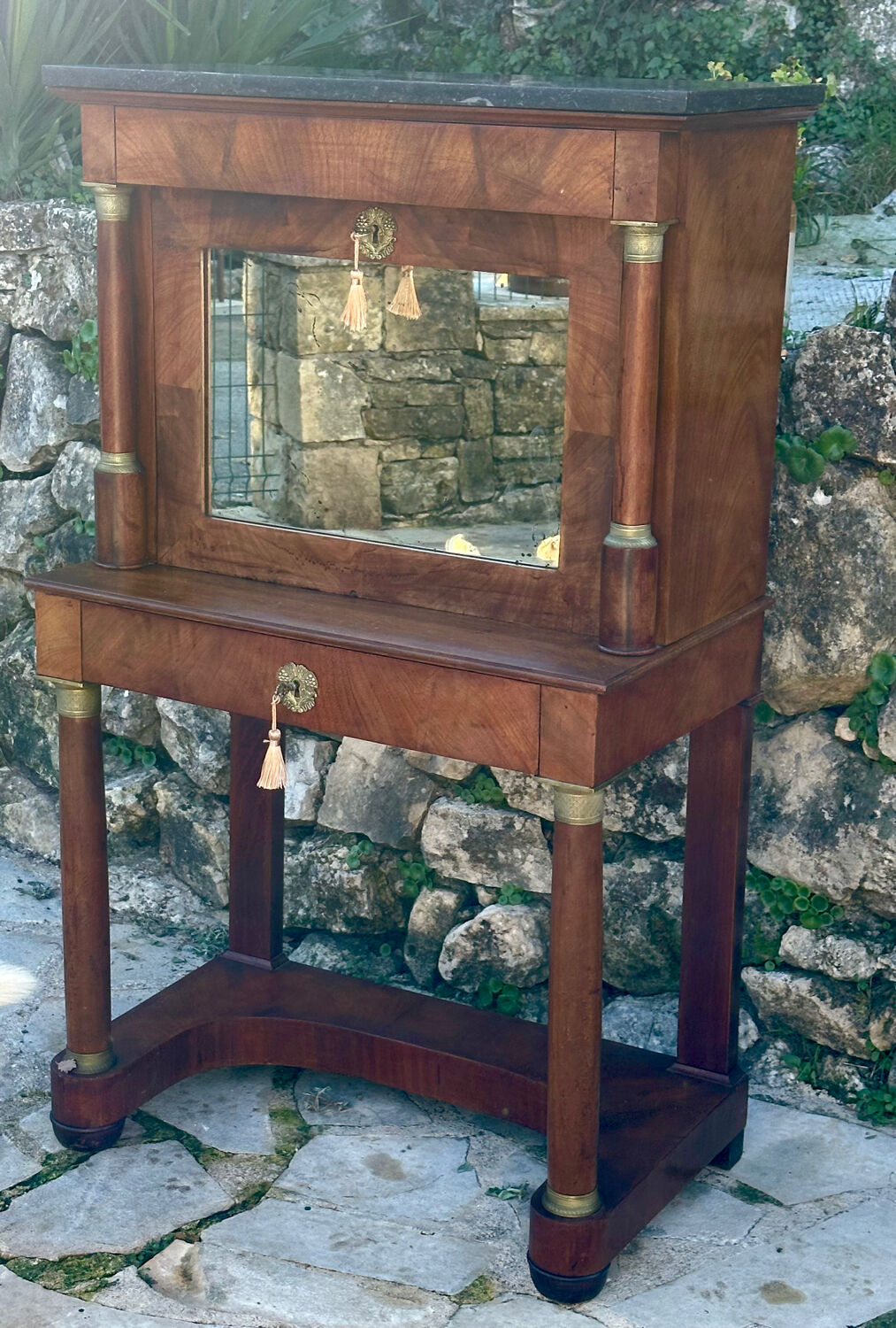 A small piece of Bonheur du jour with detached columns in Empire-era mahogany.