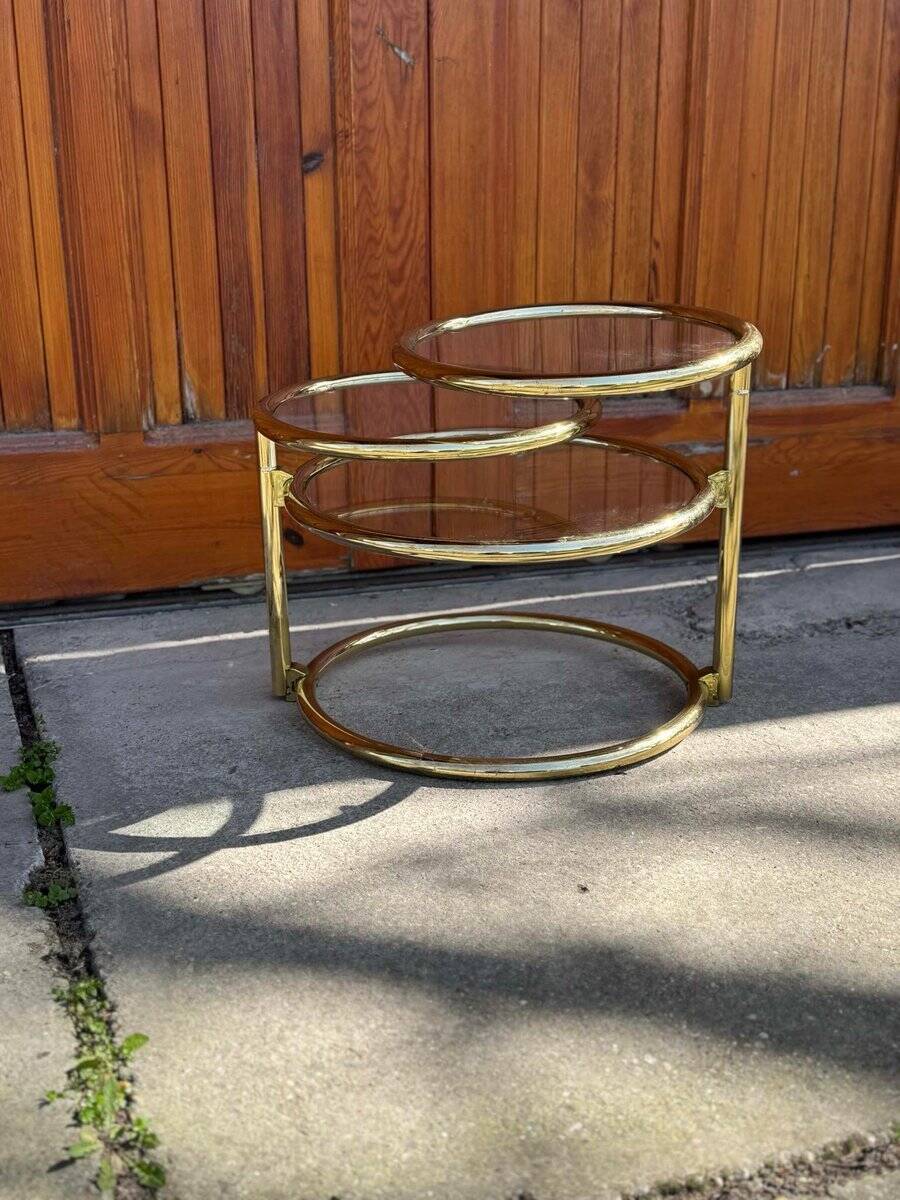 1970s swivel coffee table in gilded brass and glass, Milo Baughman style, vintage design.