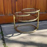 1970s swivel coffee table in gilded brass and glass, Milo Baughman style, vintage design.