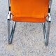 Pair of designer armchairs in orange fabrics and chrome tubes from the 70s