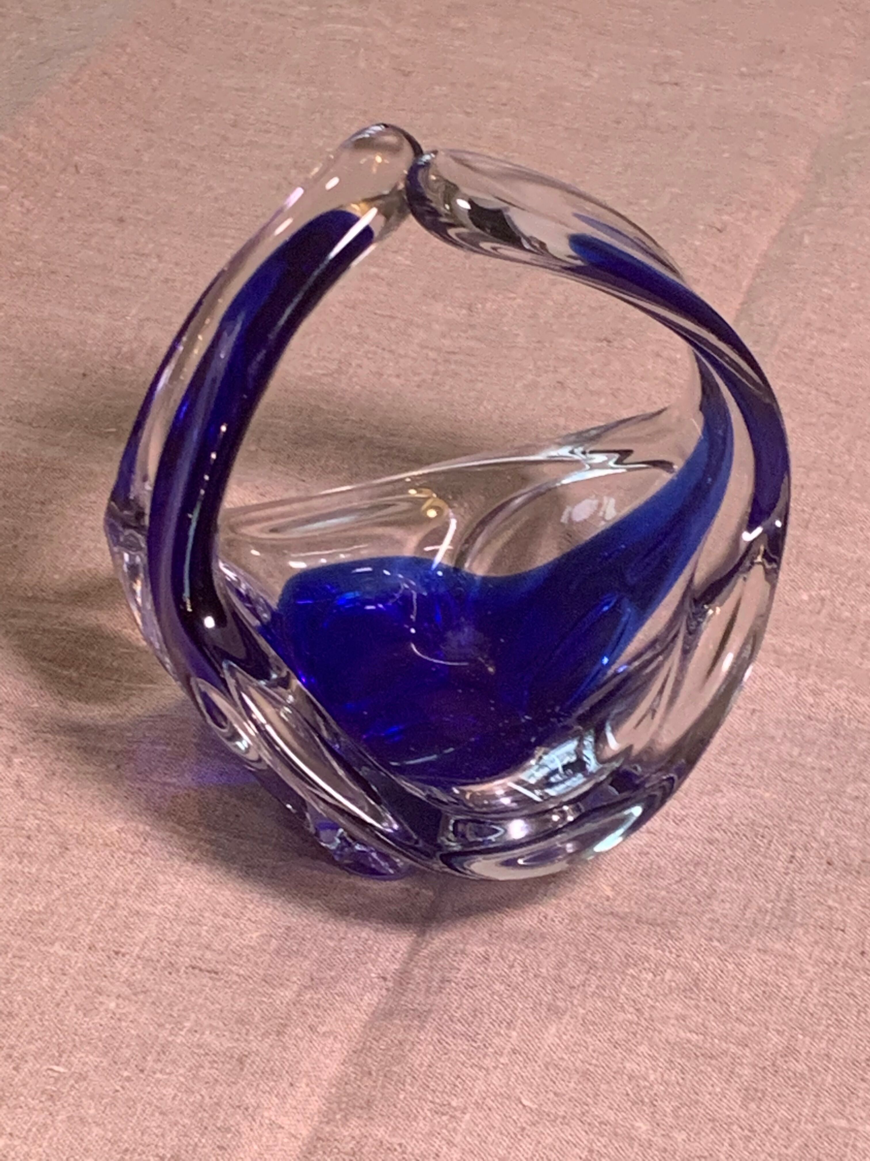 Ashtray in transparent and blue blown glass with a design shape