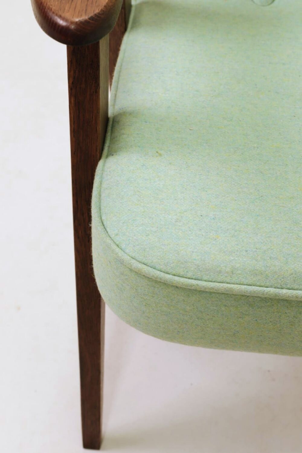 Pastel pistachio wool fabric Scandinavian armchair, oak wood.