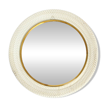 Mid Century Modern round wall mirror with a white expanded metal frame