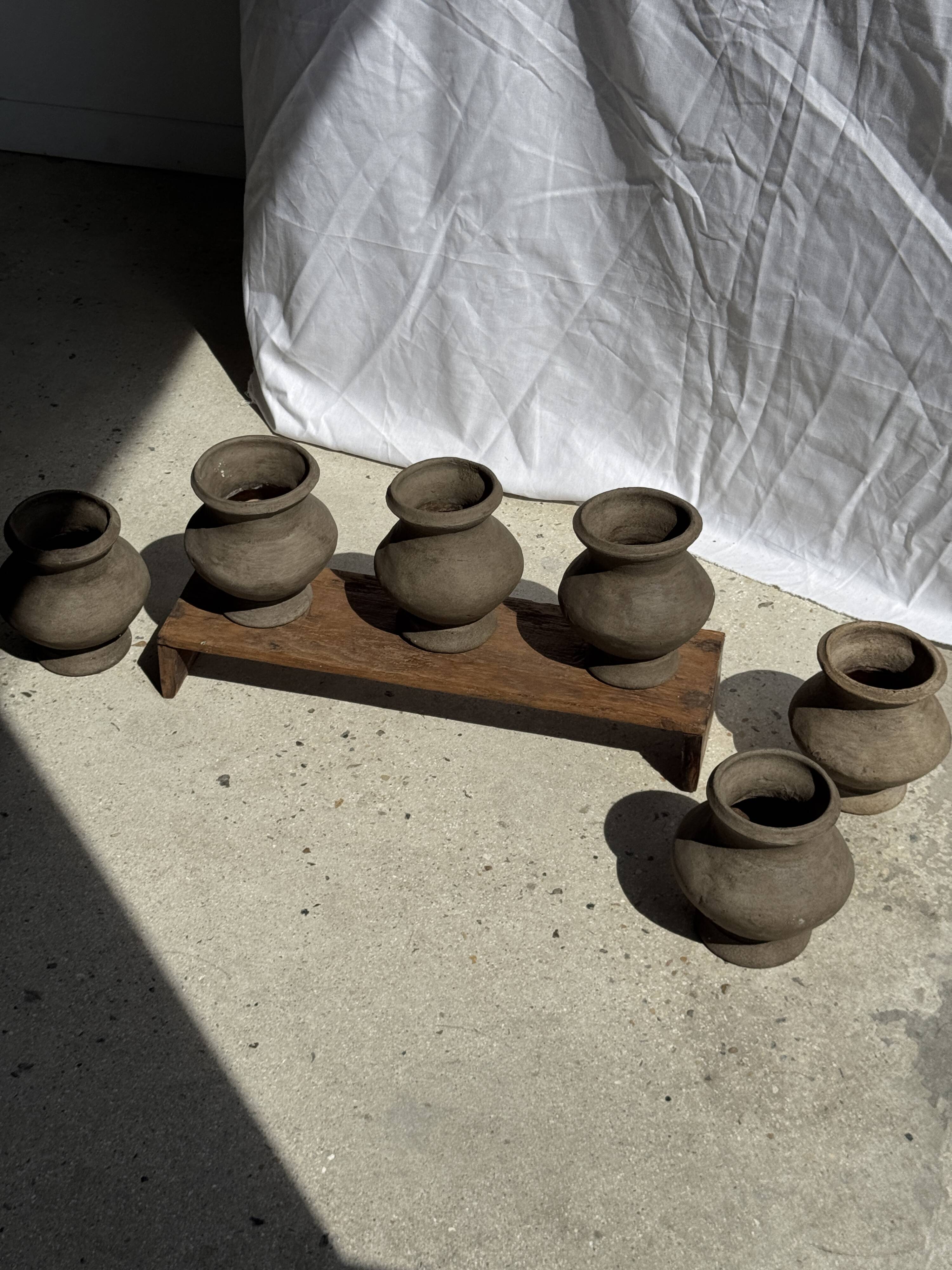Small brutalist handcrafted terracotta vase with a pedestal, Indonesian, H19 D17.