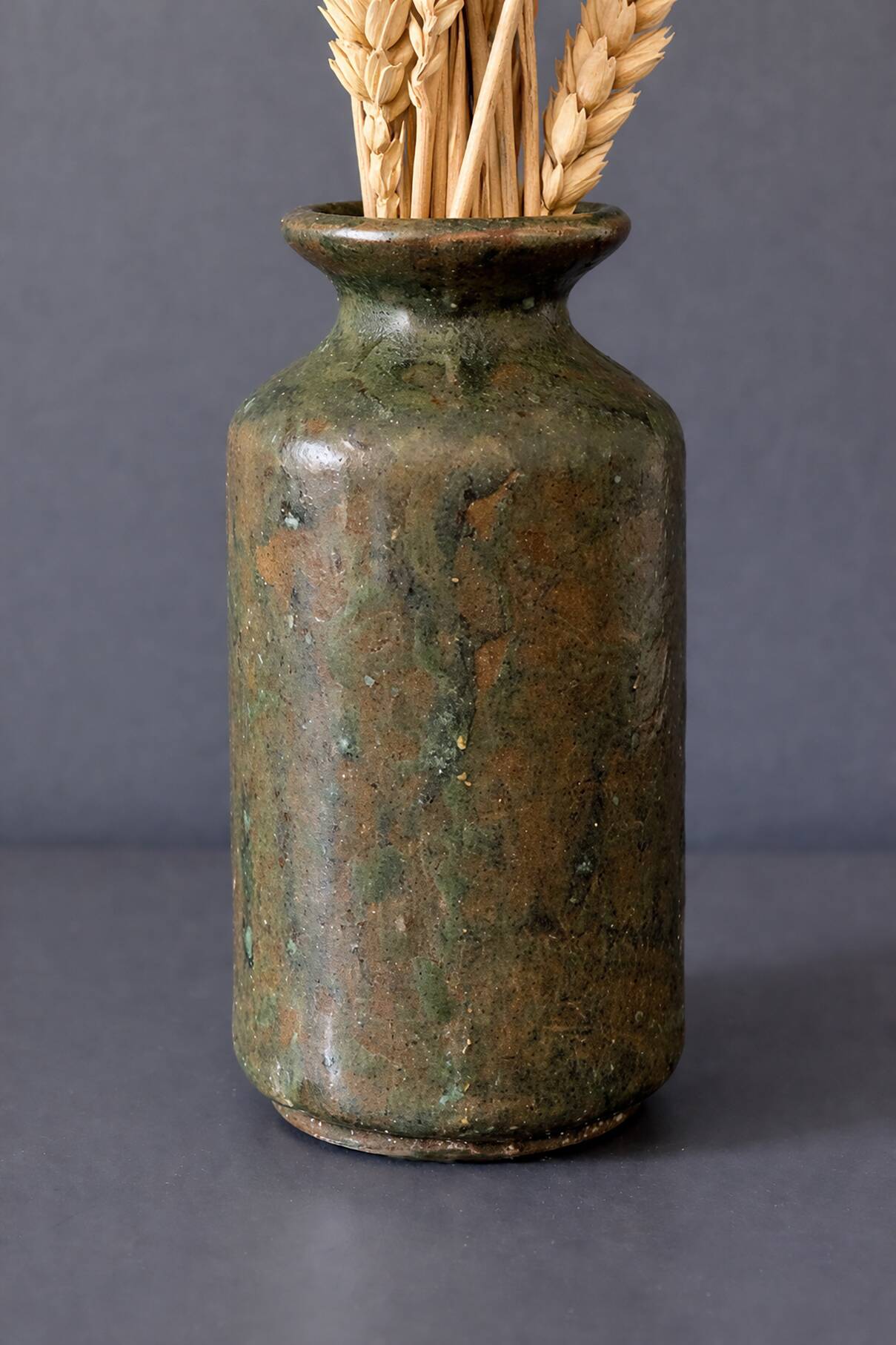 Wabi-sabi artisanal stoneware vase in green and earth tones.