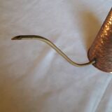 Old watering can in red copper and brass