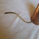 Old watering can in red copper and brass