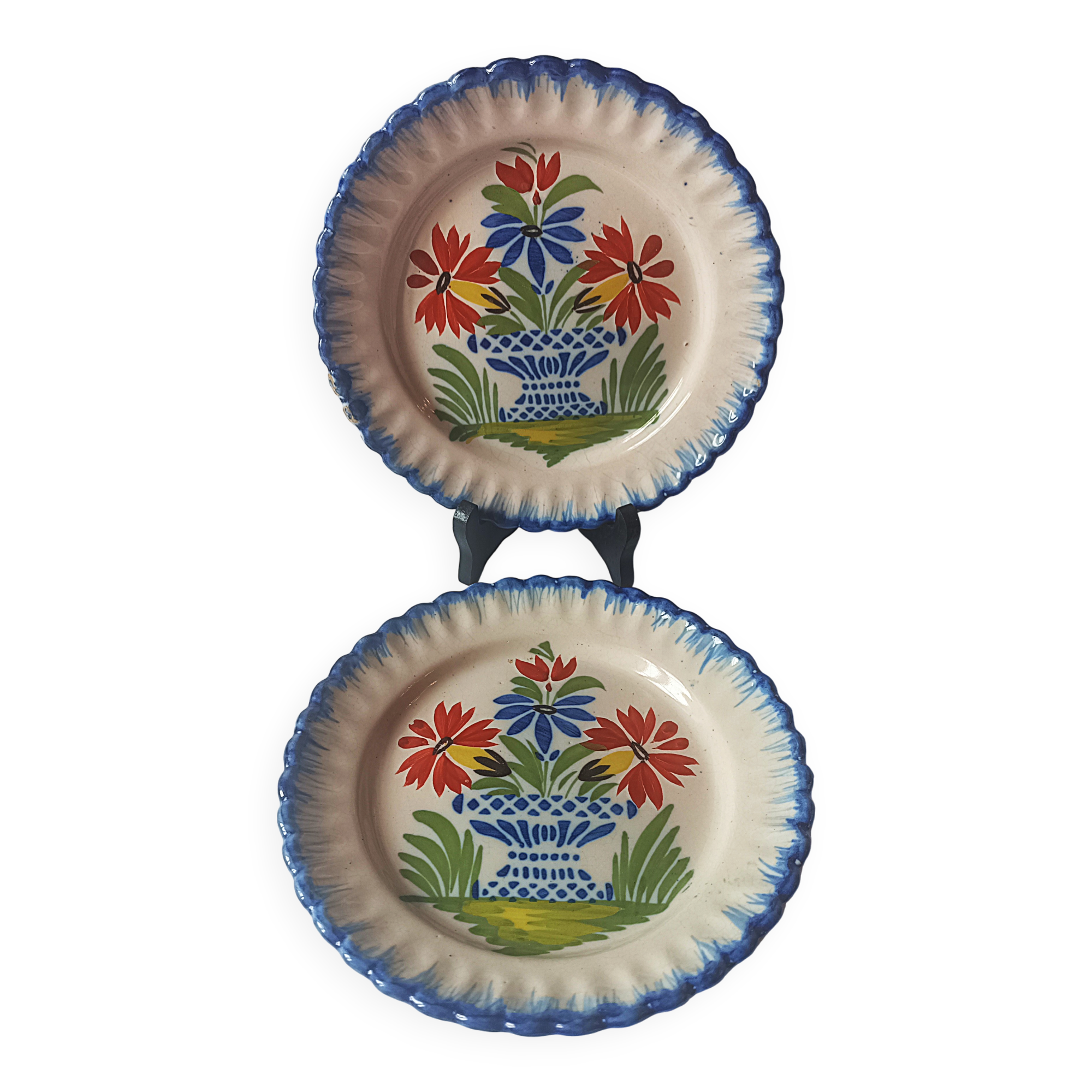 Pair of antique plates in popular earthenware with a floral basket decoration on the edge.