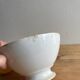 Old earthenware bowl on a pedestal, Badonviller, France.