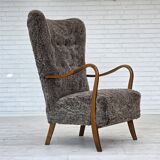 1960s, reupholstered Danish armchair, with stool, genuine sheepskin.