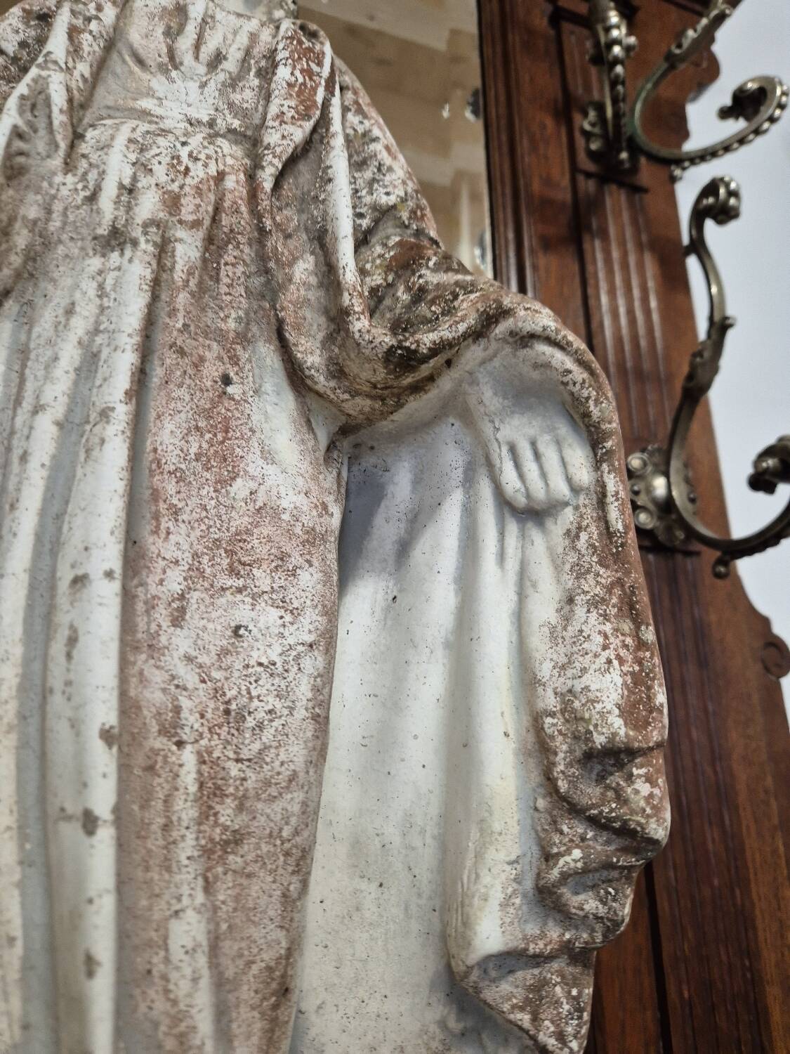 Garden statue of the Virgin Mary in old reconstituted stone