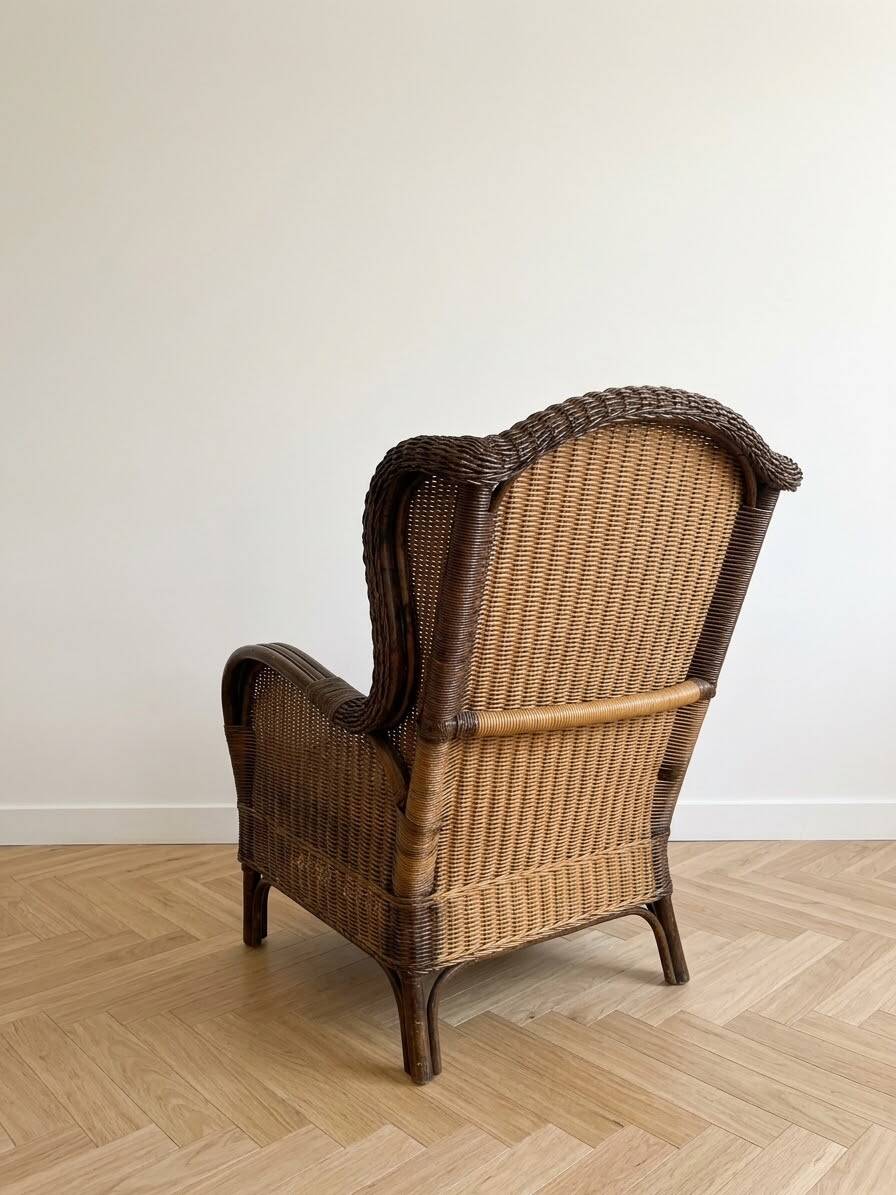 Vintage armchair in rattan and wicker with beige cushion.