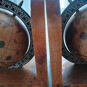 Pair of vintage bookends with rotating terrestrial globes on wooden bases in Spain