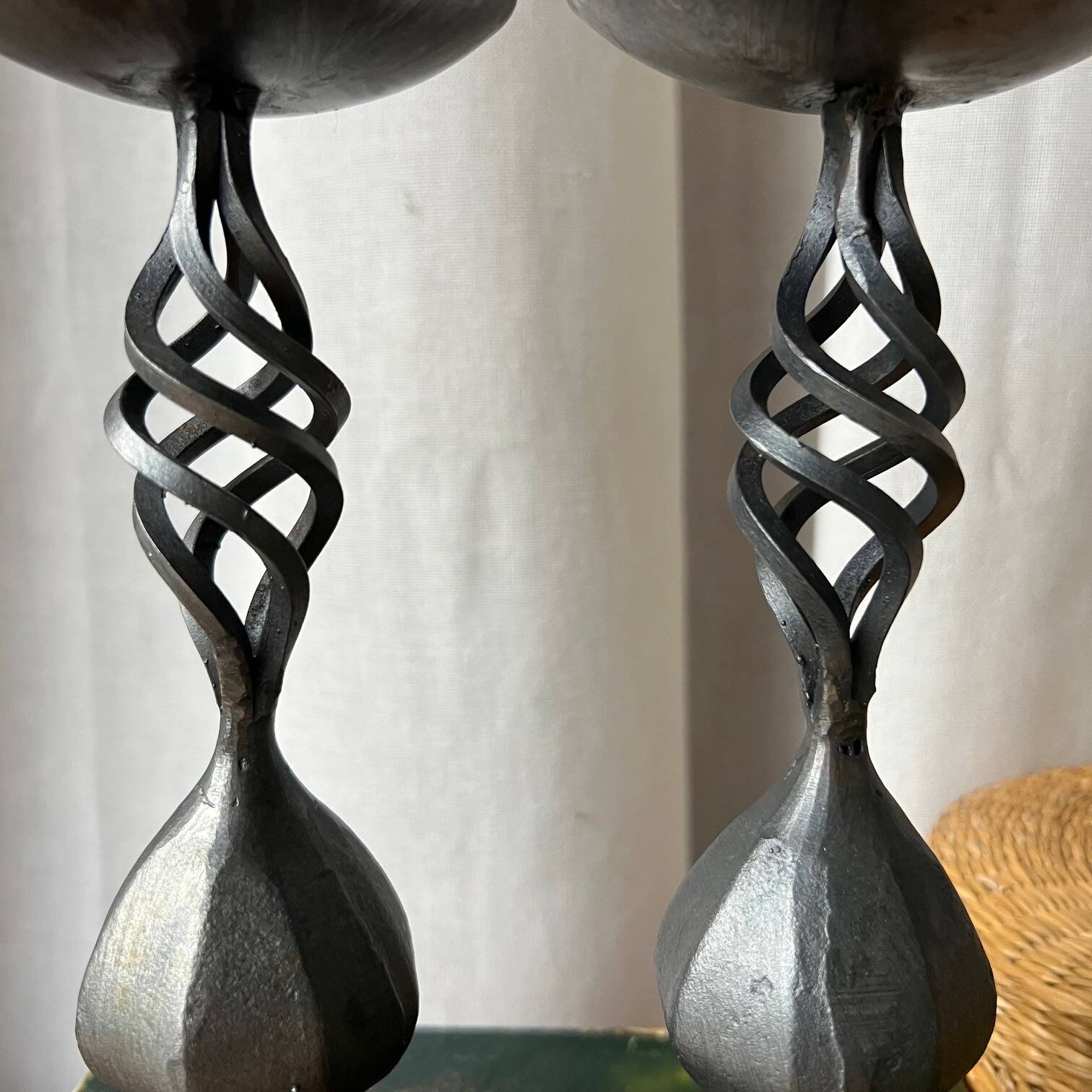 Pair of wrought iron candlesticks, black patina
