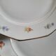 Lot de 8 assiettes en porcelaine à douze pans coupés – décor floral et