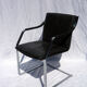 Chair with steel and leather armrests