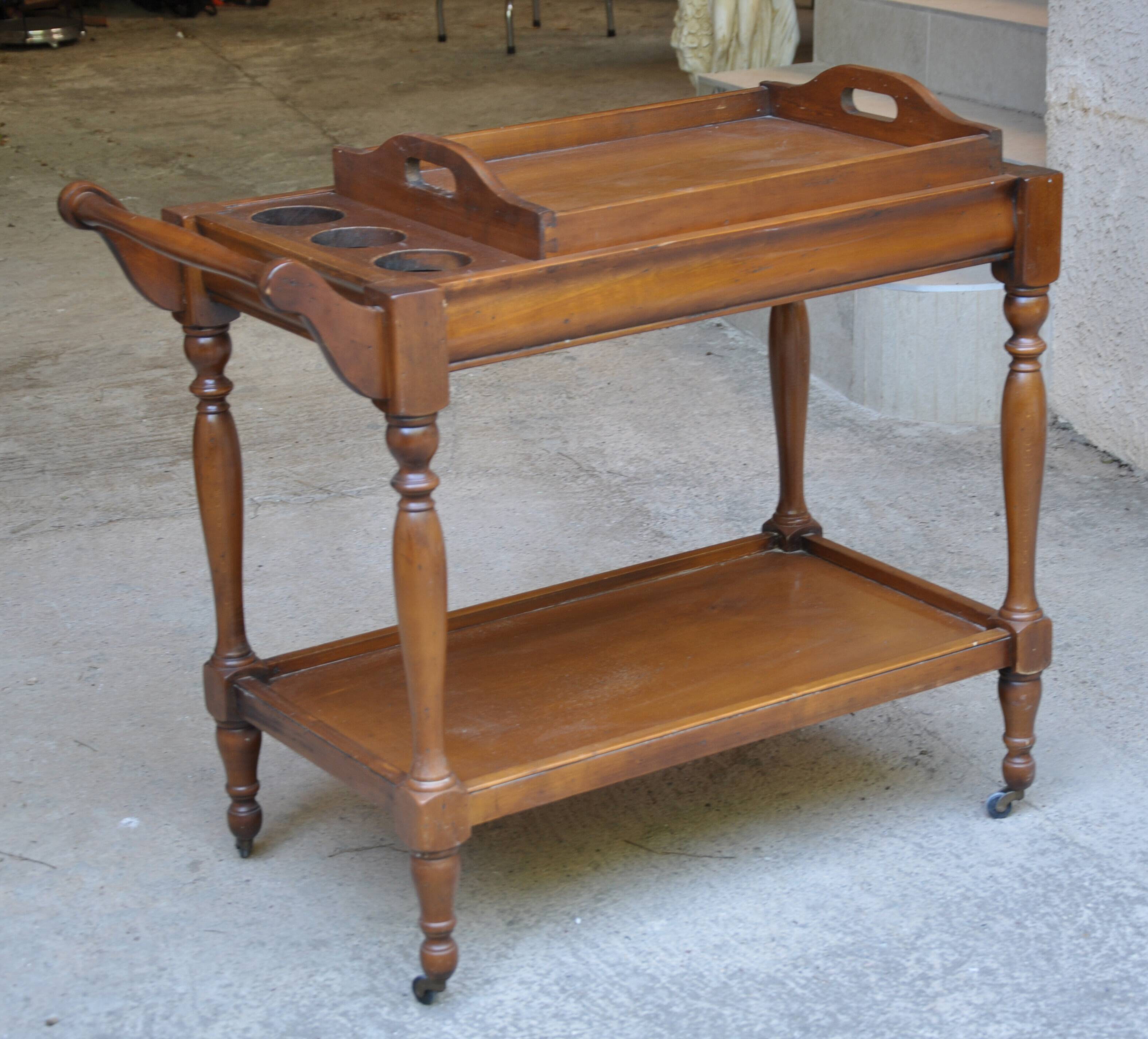 Serving table with a tray, on wheels, made of solid exotic wood.